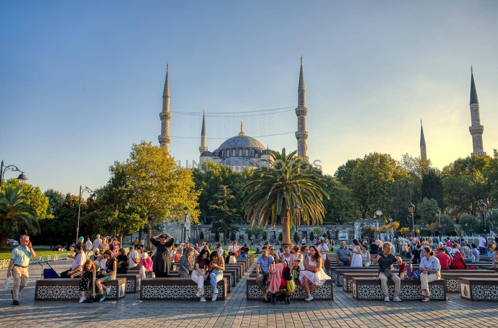 Istanbul, Turkey - August 5, 2022: View of people resting in Sultan Ahmed Blue Mosque park Istanbul, Turkey