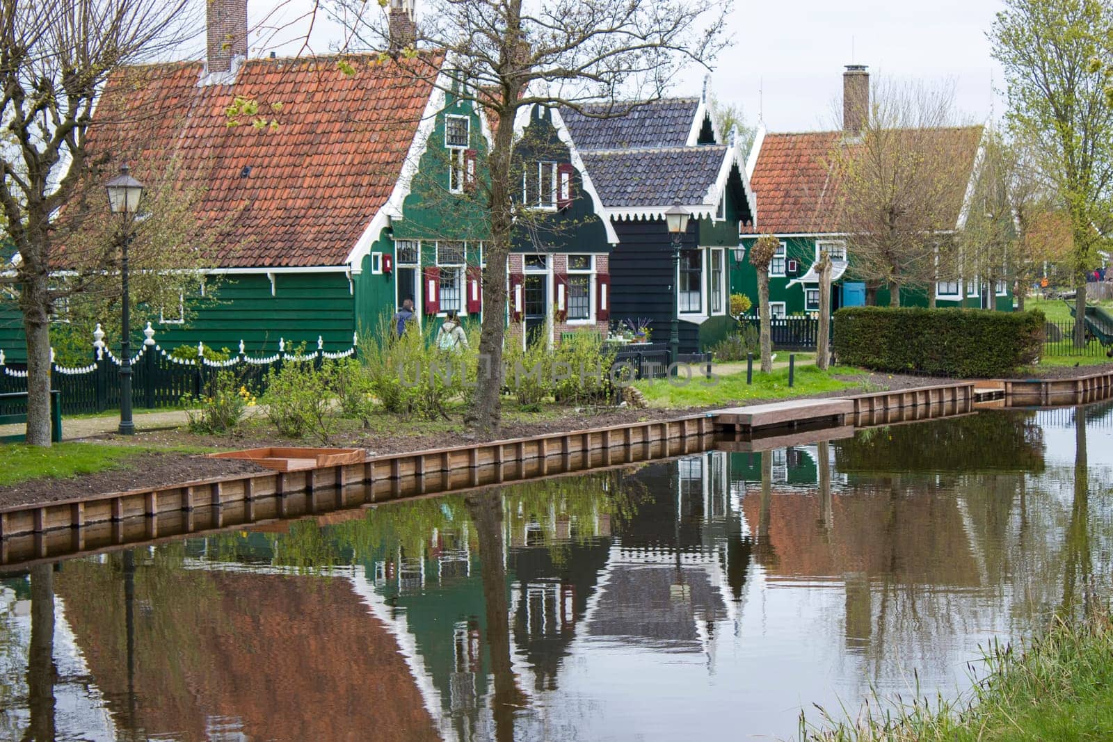Traditional Houses reflecting in the Canal in the Historic Village of Zaanse Schans on the Zaan River in the Netherlands