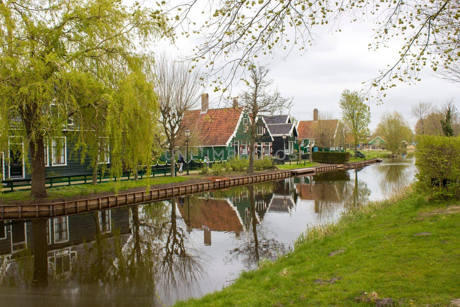 Traditional Houses reflecting in the Canal in the Historic Village of Zaanse Schans on the Zaan River in the Netherlands