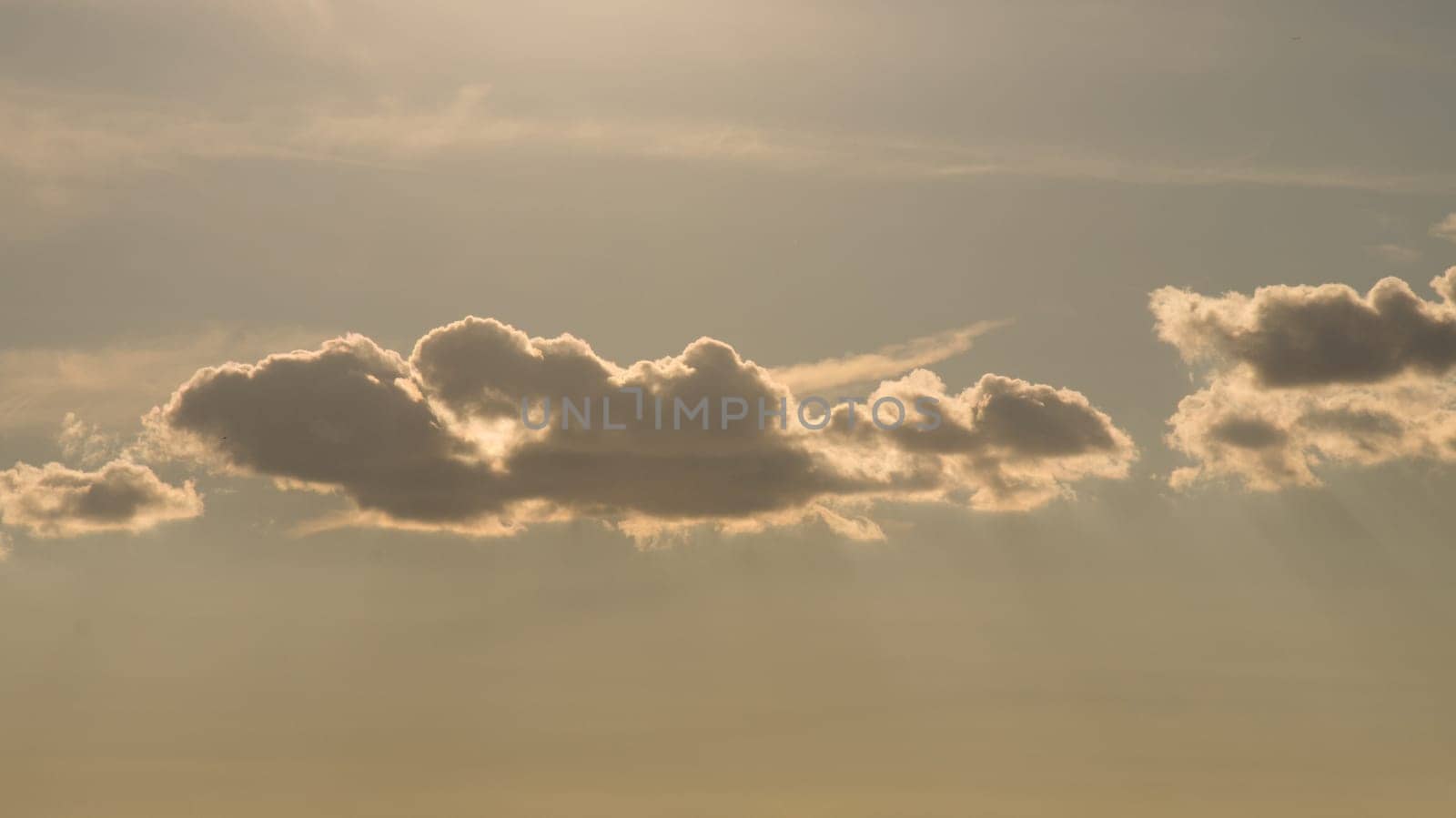 Clouds illuminated by the sun in the sky as background. Background image for further editing