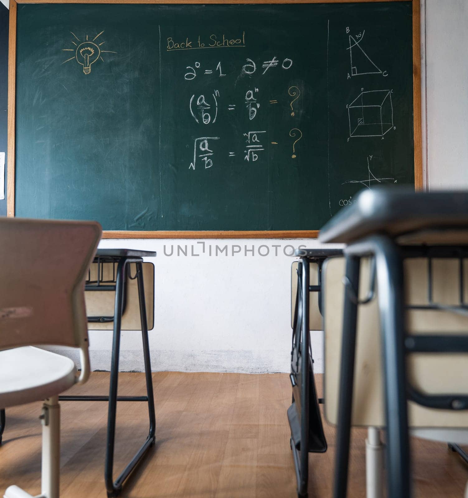 Empty classroom with chairs elementary school desks and chalkboard, Interior of a school class room with table and blackboard at high school, Education Institution in the daytime