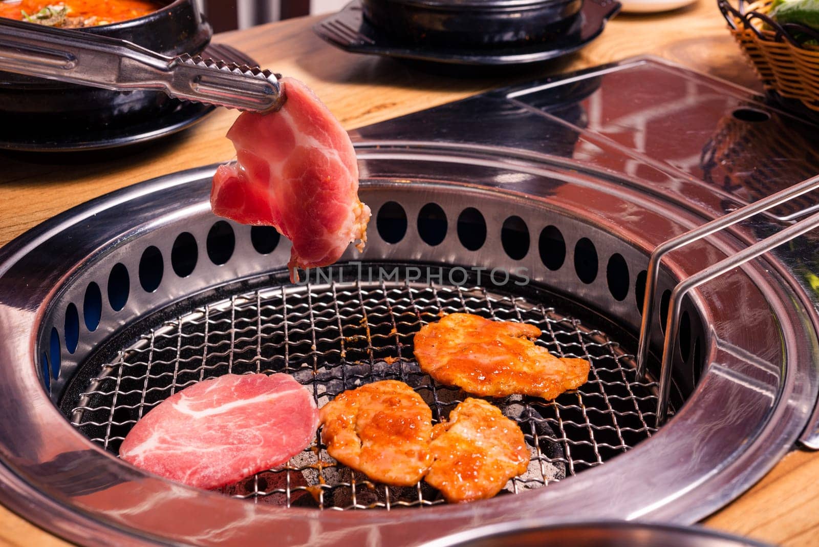 Korean beef barbecue on hot coals. Grilling meat pork Korean BBQ traditional style on stove serve in restaurant, Japanese food