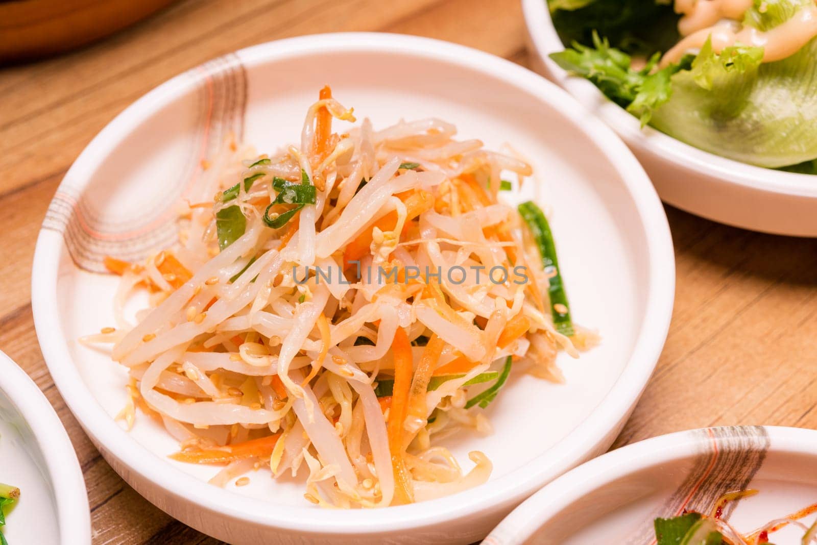 Spicy Kimchi. Korean pickle or Pickled radish vegetables and seasoning on bowl on wood table background, Japanese food