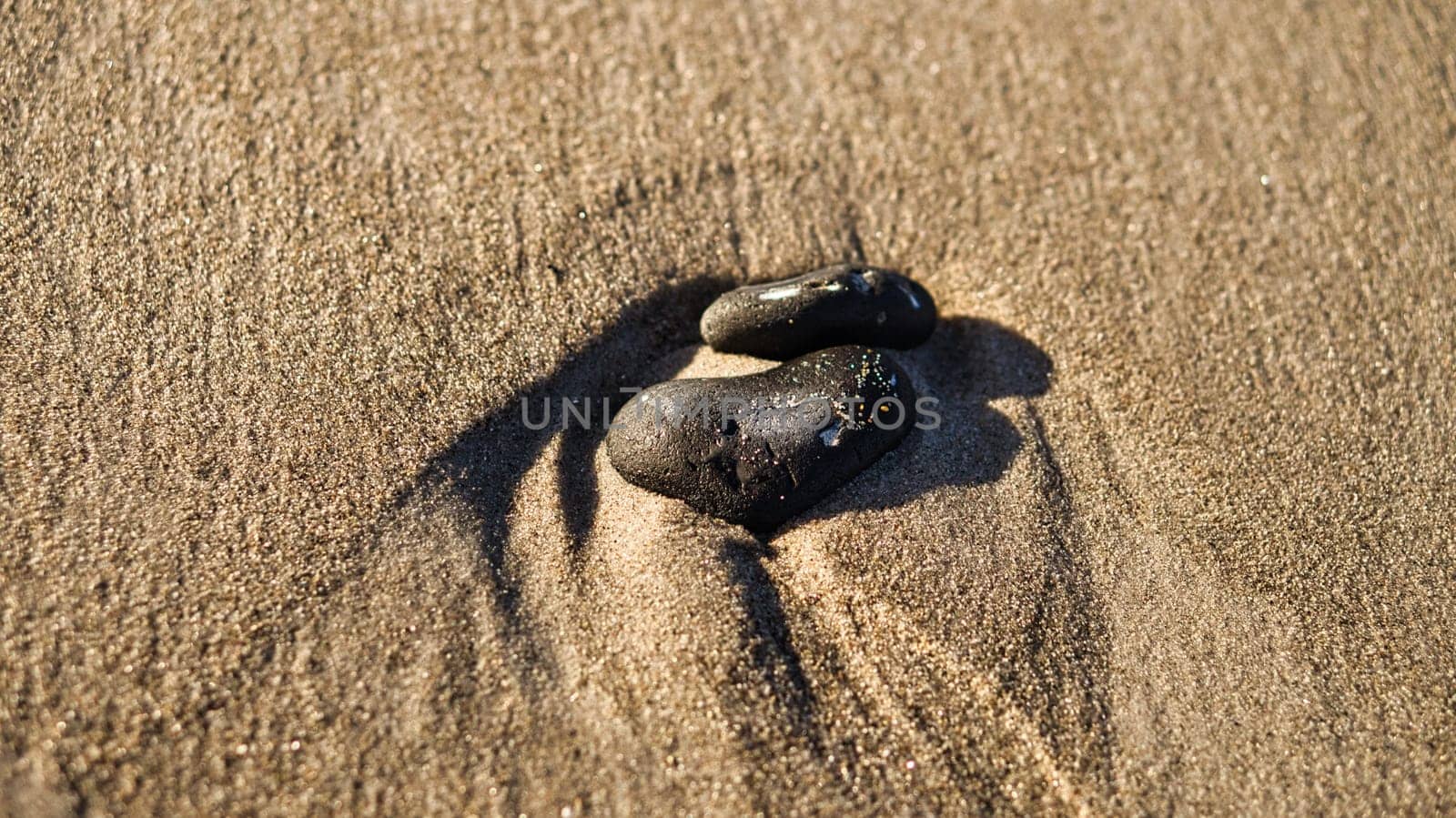 heart-shaped stone in the sand of the beach on the Baltic Sea. Romantic symbol for those in love. Small sign as still life.