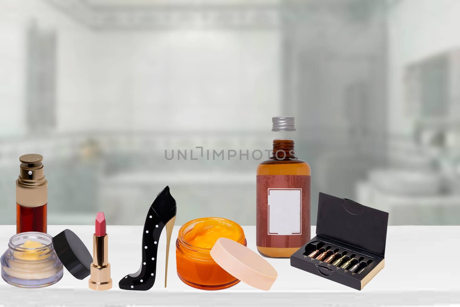 Decorative composition of various colorful beauty and makeup products on table over blurred bathroom background. Space for advertising and design. Serum for face, perfume, skin care and spa products.