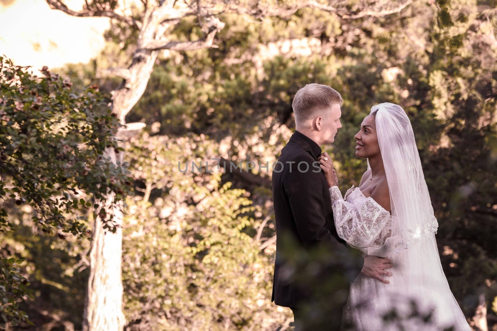 Portrait of young beautiful interracial newlyweds on a walk