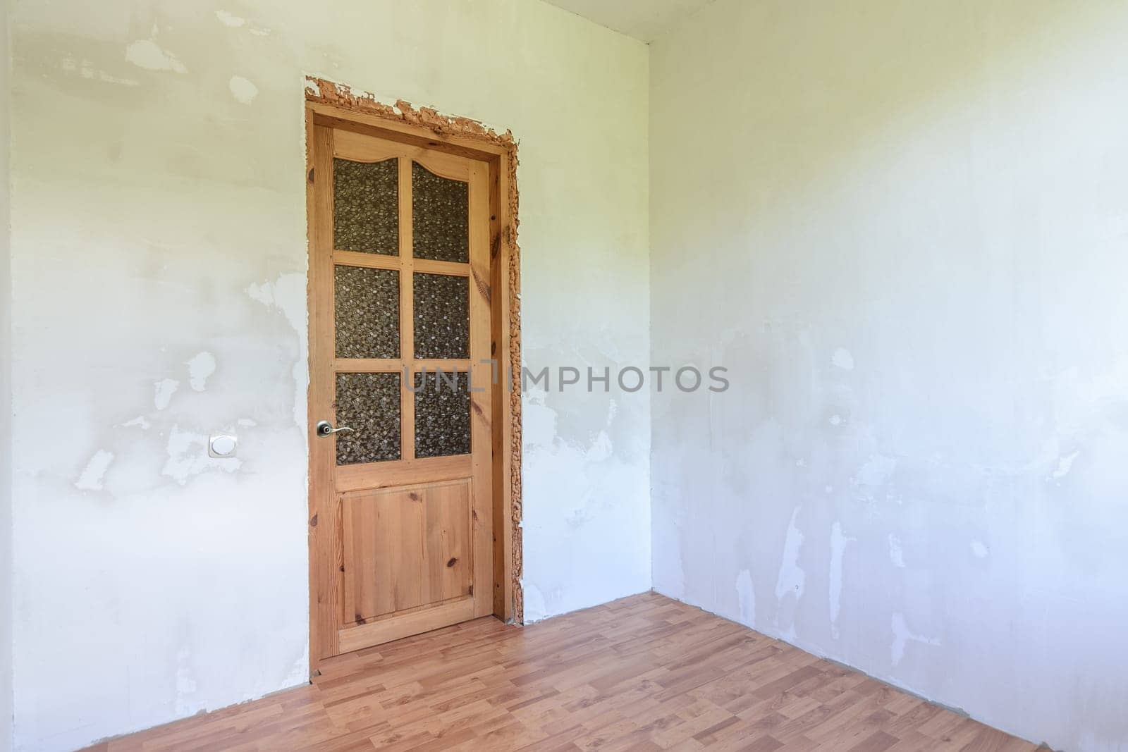 View of the front door in a small room with a fine finish after renovation