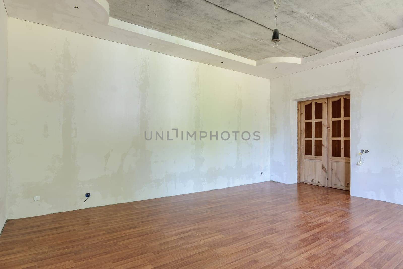 Interior of an empty room with a final renovation under a wallpaper sticker