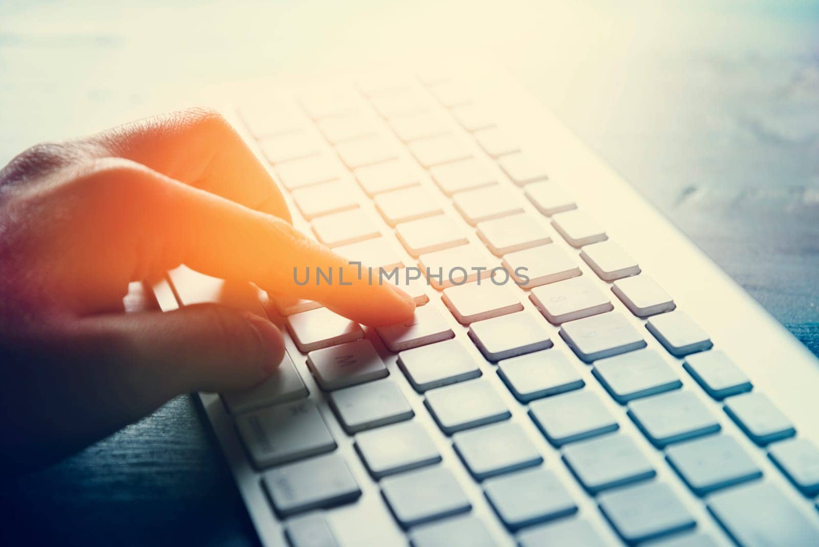 Closeup of peroson hand typing on computer keyboard device.Internet business and modern techology background concept. Woman using office computer for freelance work, e-commerce,e-mail and e -banking.