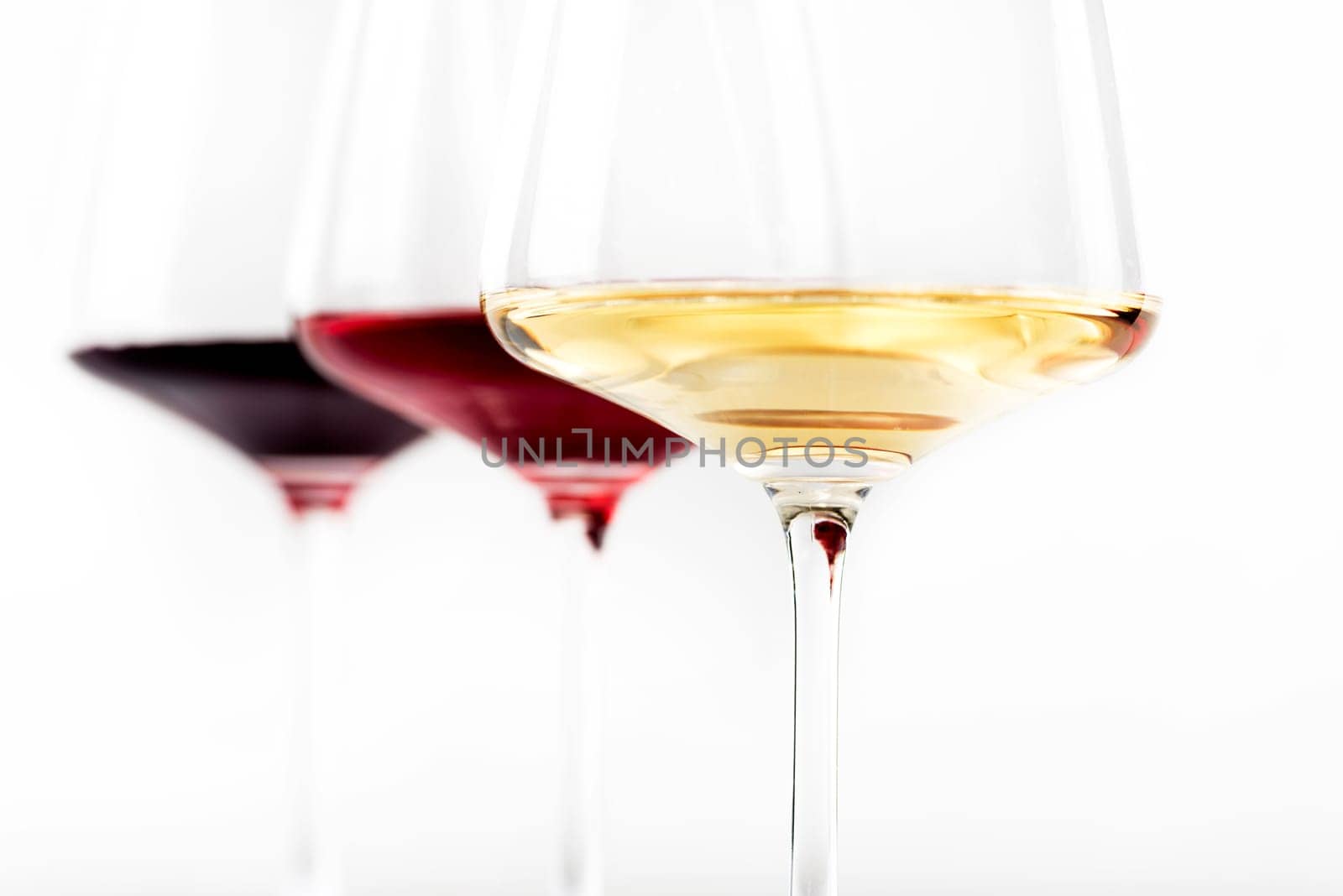 Three glass of red, rose and white wine isolated over white background. Wine list menu design with copyspace.