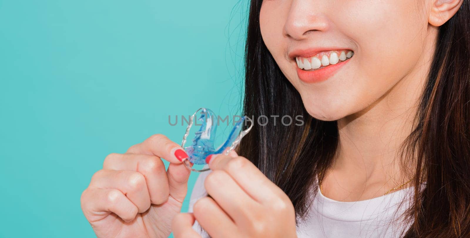 Teeth retaining tools after removable braces, Portrait young Asian beautiful woman smiling holding silicone orthodontic retainers for teeth, Orthodontics dental healthy care concept