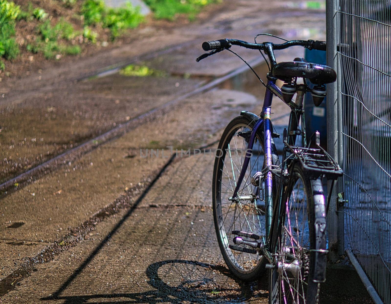 Parked bicycle at a construction fence in Berlin. In the capital, bicycles are parked at all free places.