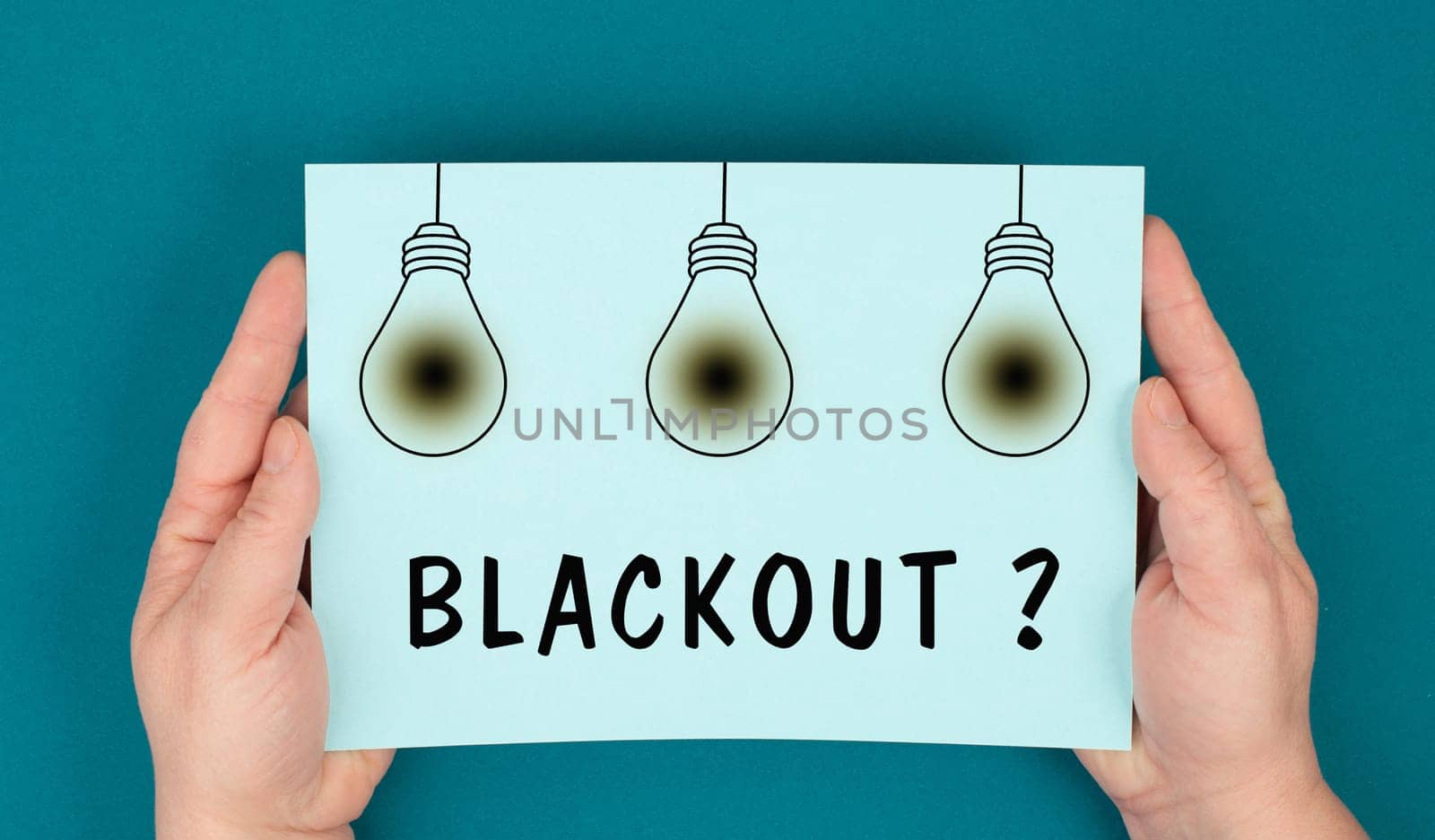 The word blackout is standing under the blown lightbulbs, power cut out, uncertain energy supply