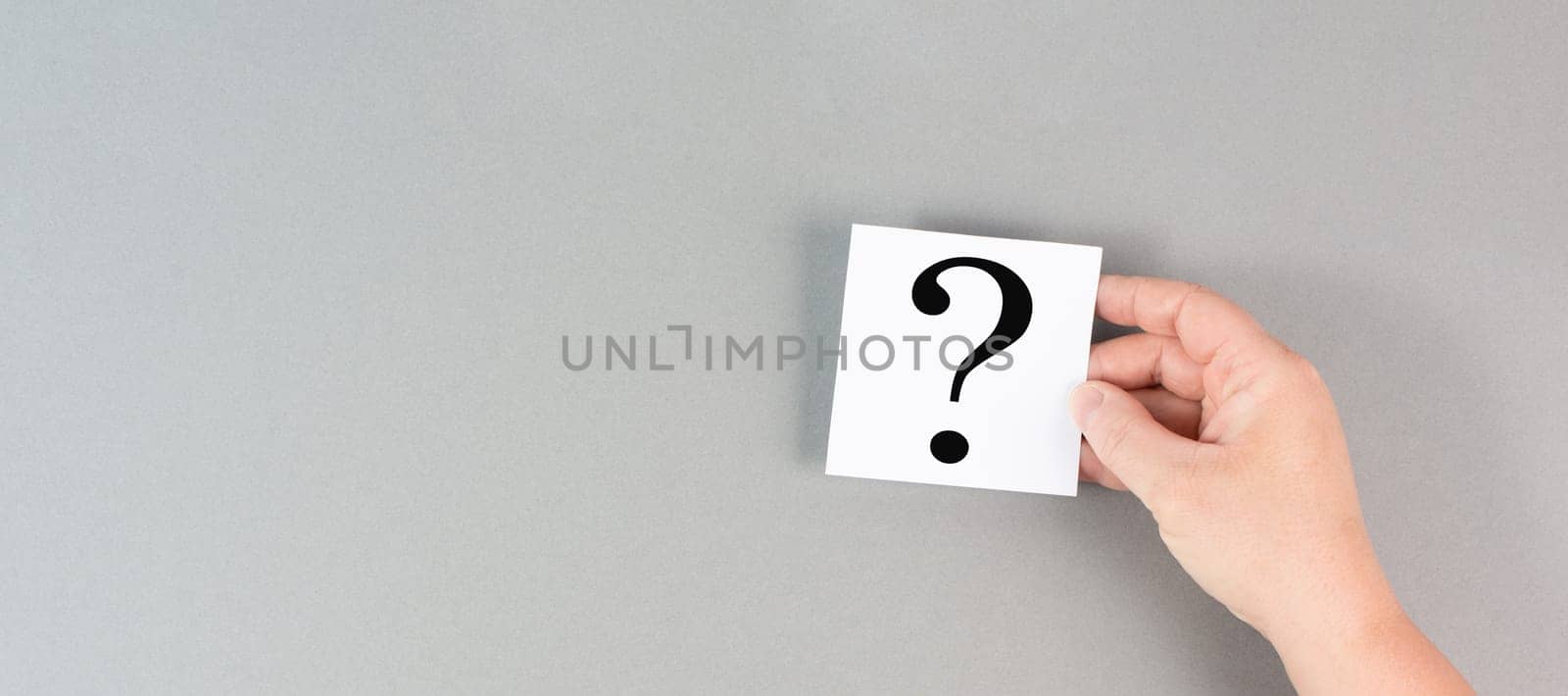 Question mark in the hand, looking for an answer, searching for knowledge, problem solving, business and education concept
