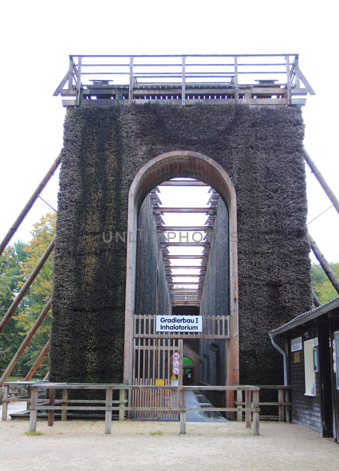 A graduation tower (occasionally referred to as a thorn house is a structure used in the production of salt which removes water from a saline solution by evaporation, increasing its concentration of mineral salts.Ein Gradierwerk (auch Leckwerk) ist eine Anlage zur Salzgewinnung. Sie besteht aus einem Holzgerüst, das mit Reisigbündeln (vorwiegend Schwarzdorn) verfüllt ist