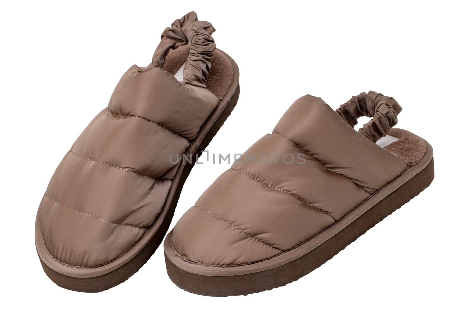 Slippers isolated. Close-up of a pair of female brown warm and soft cosy terry house slippers isolated on white background.  Womans shoes. Macro.