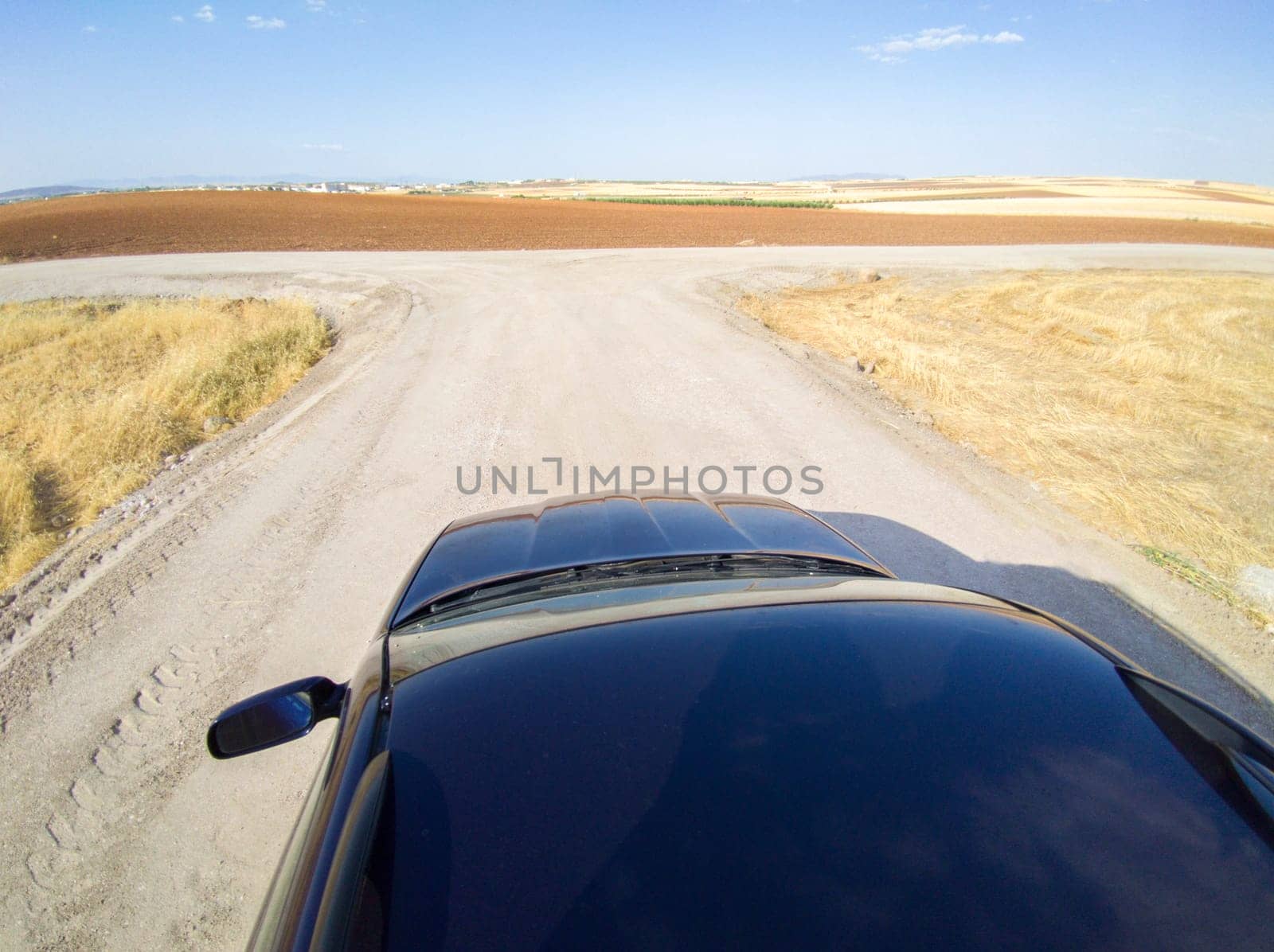 Driving off road by rural tracks. View from car roof