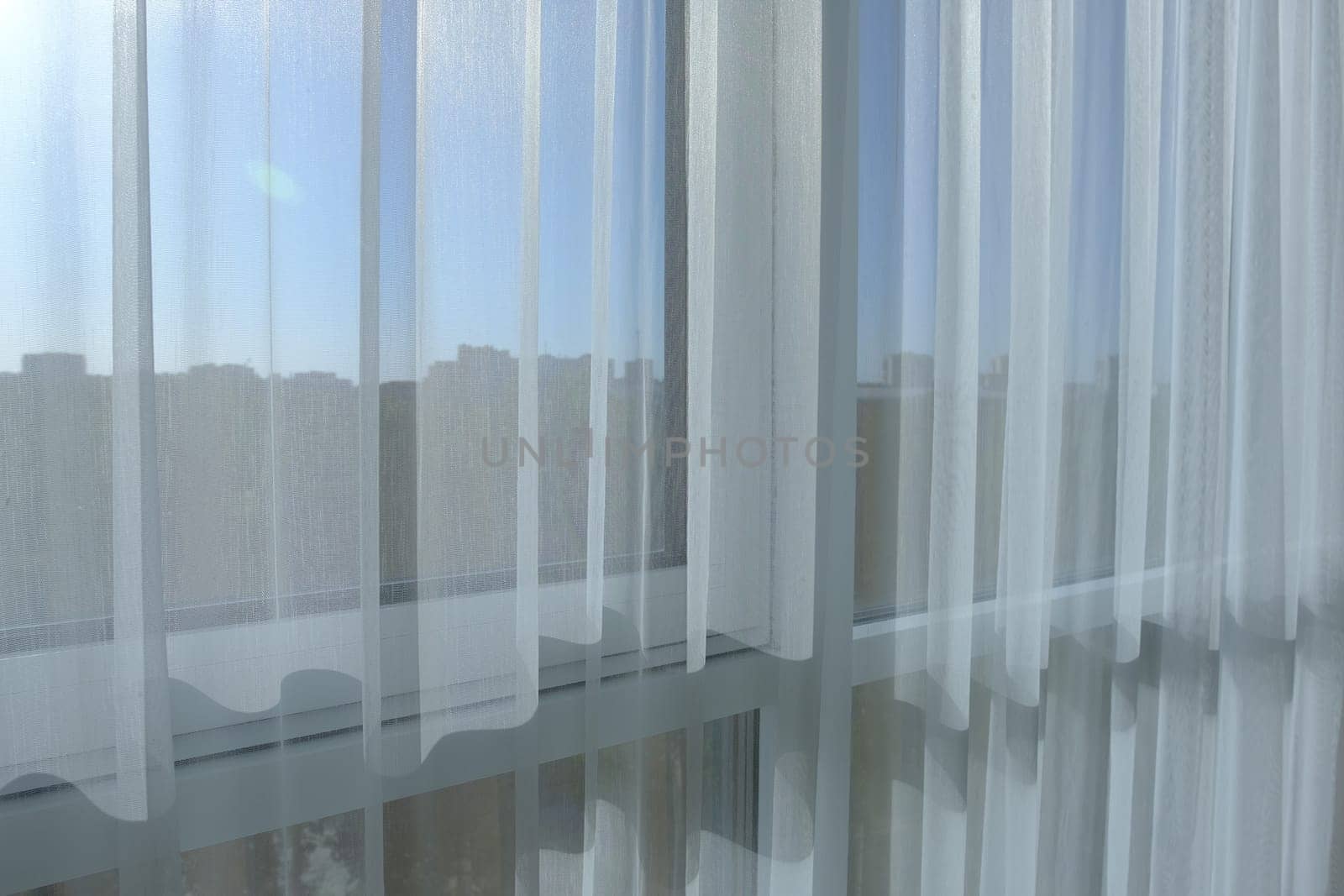 White curtains, translucent sunlight, morning light blurred houses