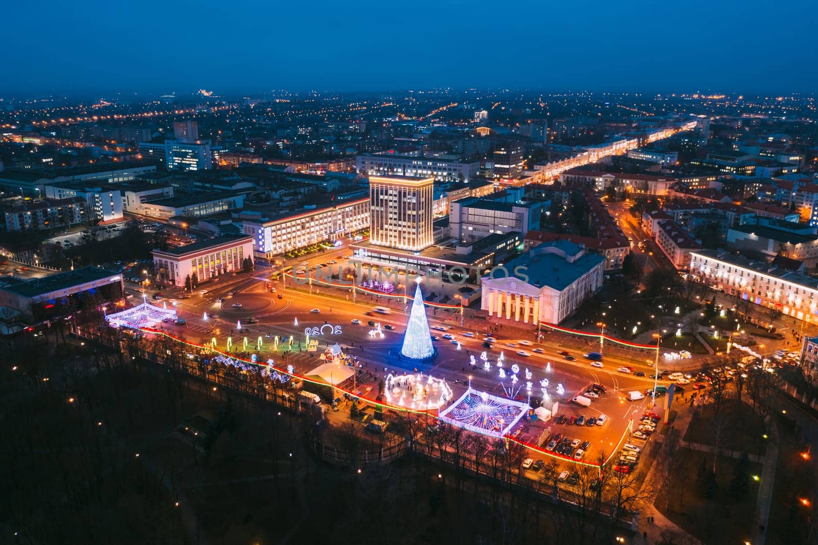Gomel, Belarus. Main Christmas Tree And Festive Illumination On Lenin Square In Homel. New Year Celebration In Belarus. Aerial Night View.