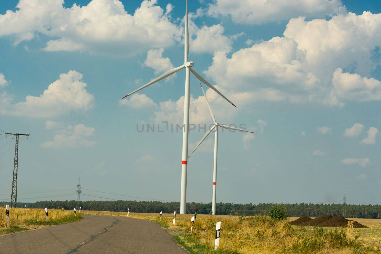 Sustainable green energy. Electric windmill generators in the sunrise