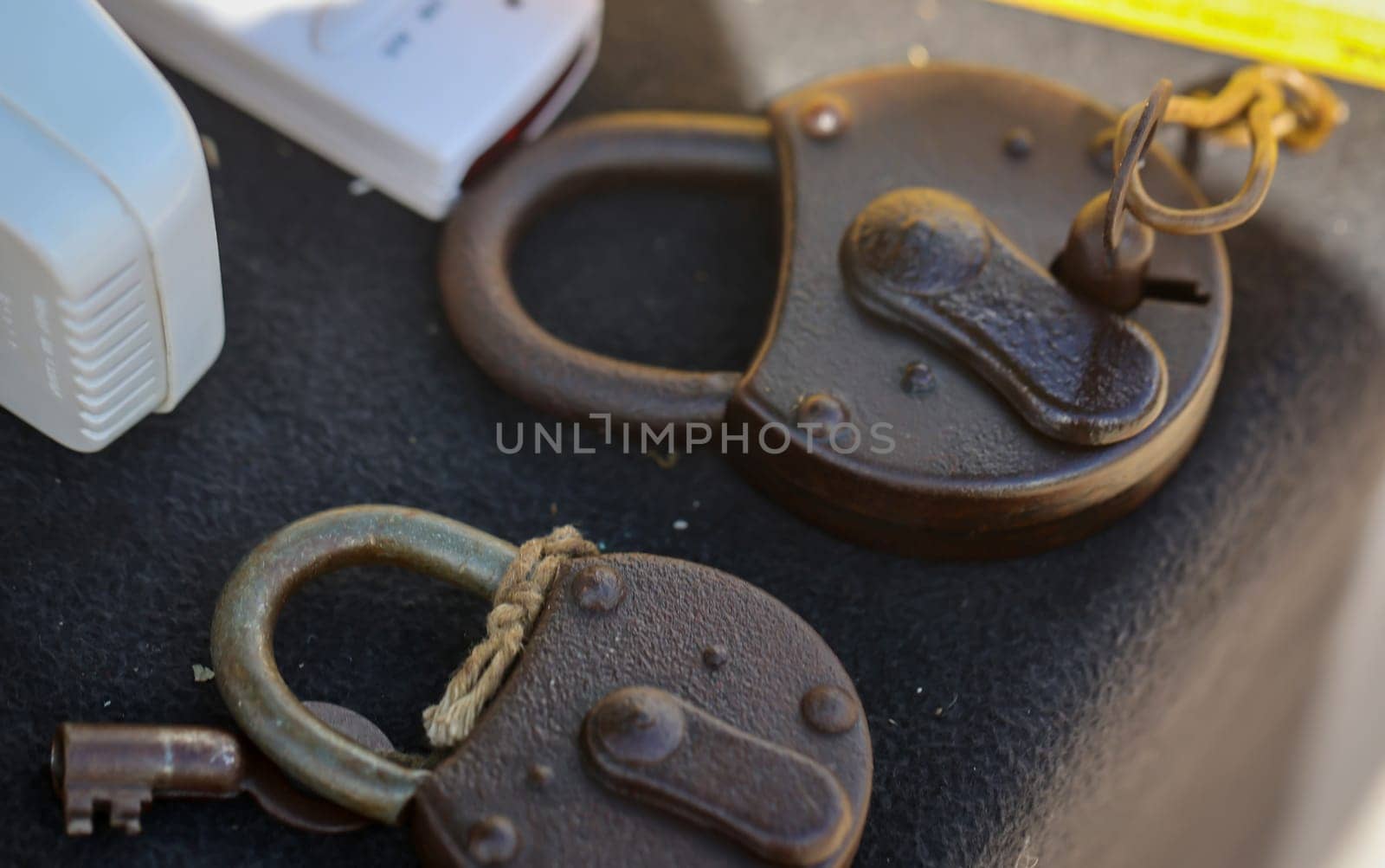 Two old padlocks lie on a table.