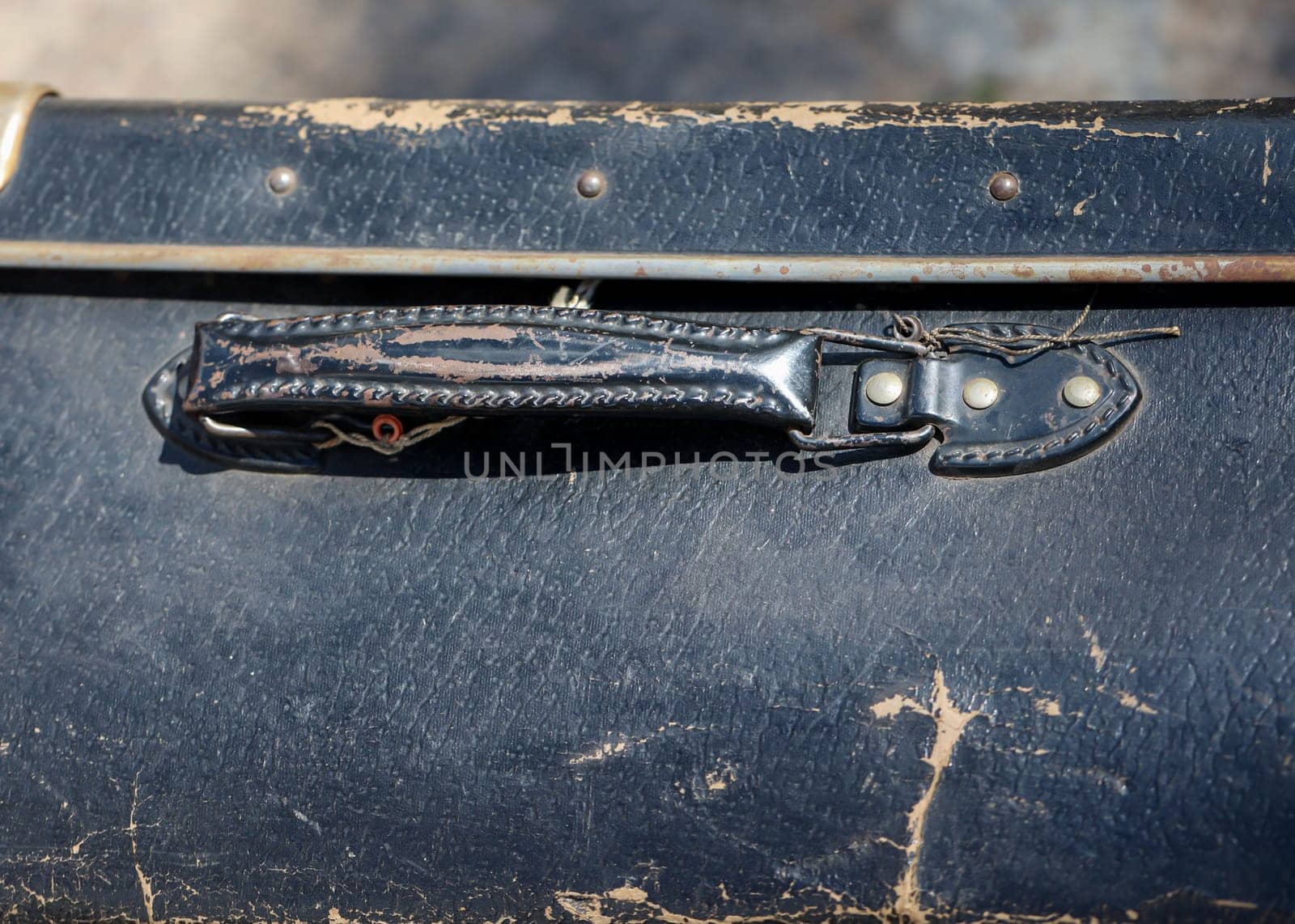 A close-up, detail shot of an old leather suitcase.