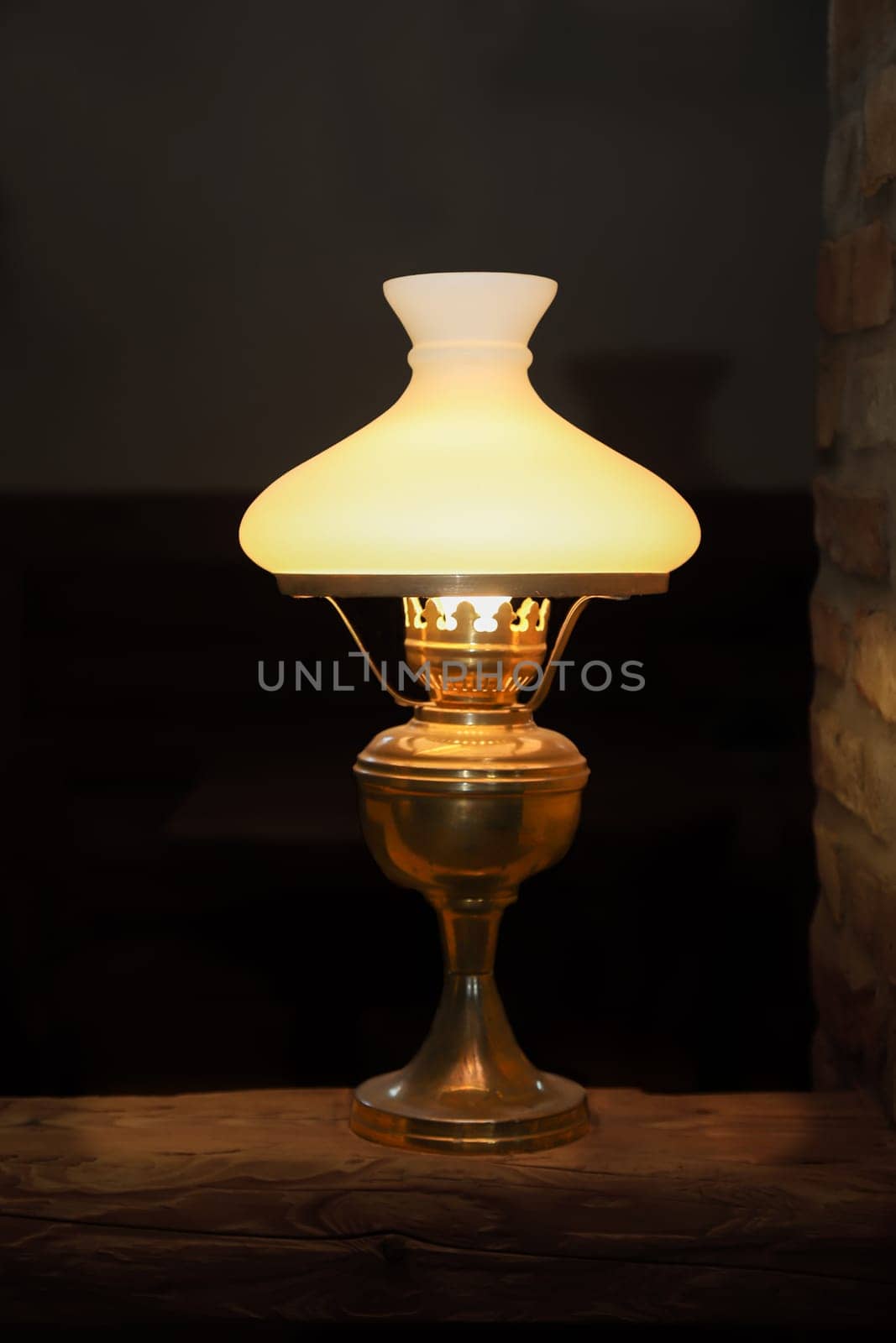 A floor lamp on a base made of a wooden post.