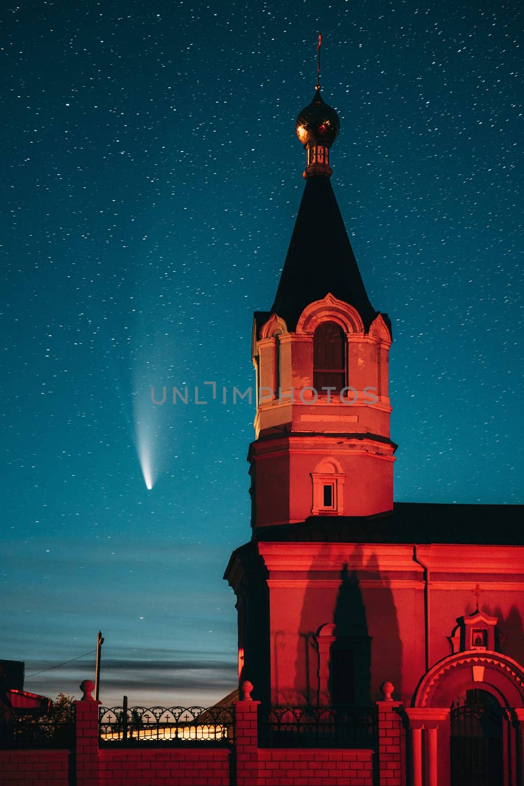 Korma Village, Dobrush District, Belarus. Comet Neowise C2020f3 In Night Starry Sky And St. John The Korma Convent Church In Korma Village. Famous Orthodox Church And Historic Heritage.
