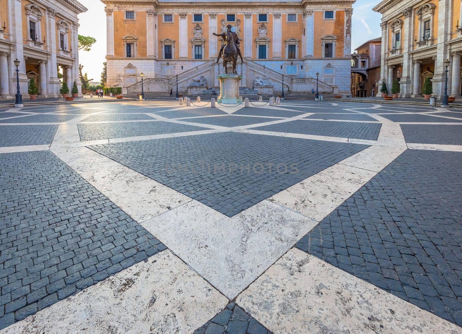 ROME, ITALY - CIRCA AUGUST 2020: Capitolium Square (Piazza del Campidoglio). Made by Michelangelo, it is home of Rome (Roma) City Hall. Sunrise light, before turist arrival.