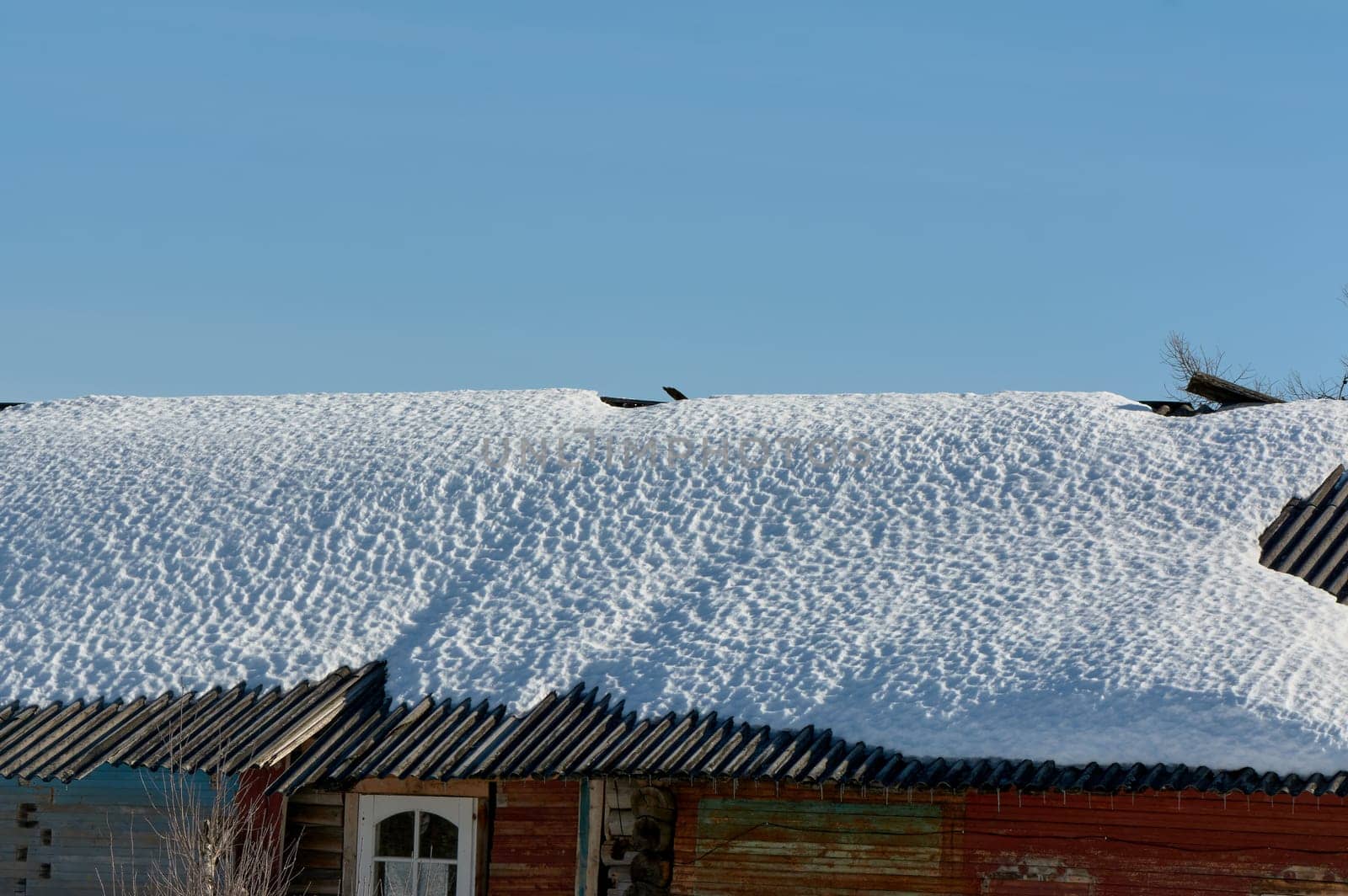 a block of ice hangs from the roof of the house. High quality photo