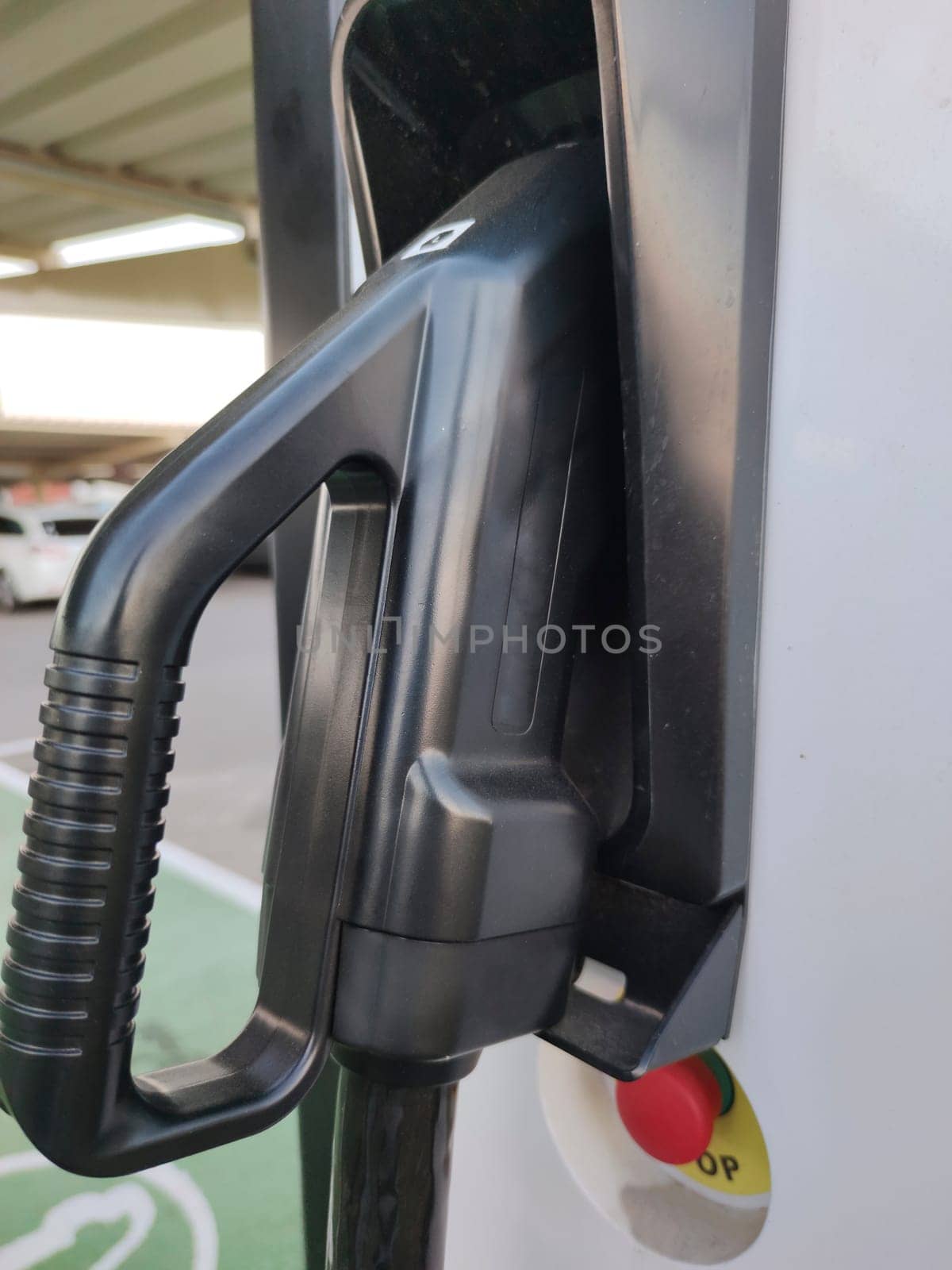 Vehicle connector at electric car charging station. Selective focus