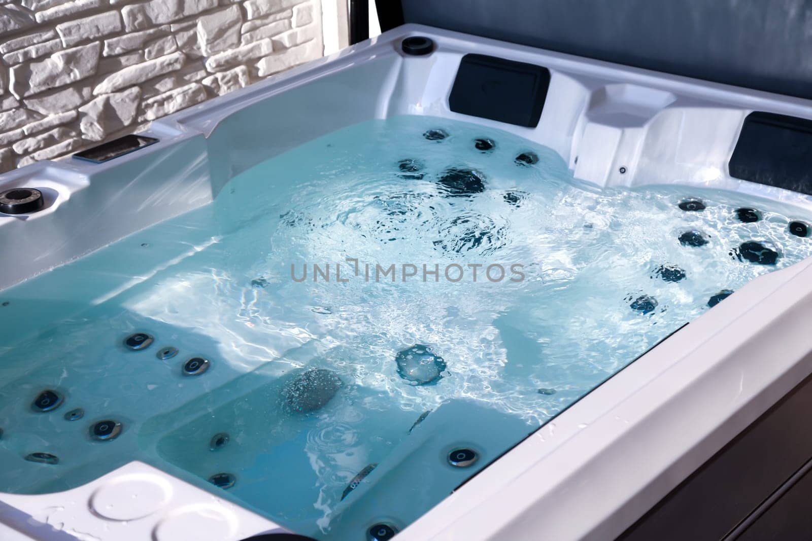 Details of a whirlpool with many jets for massage.
