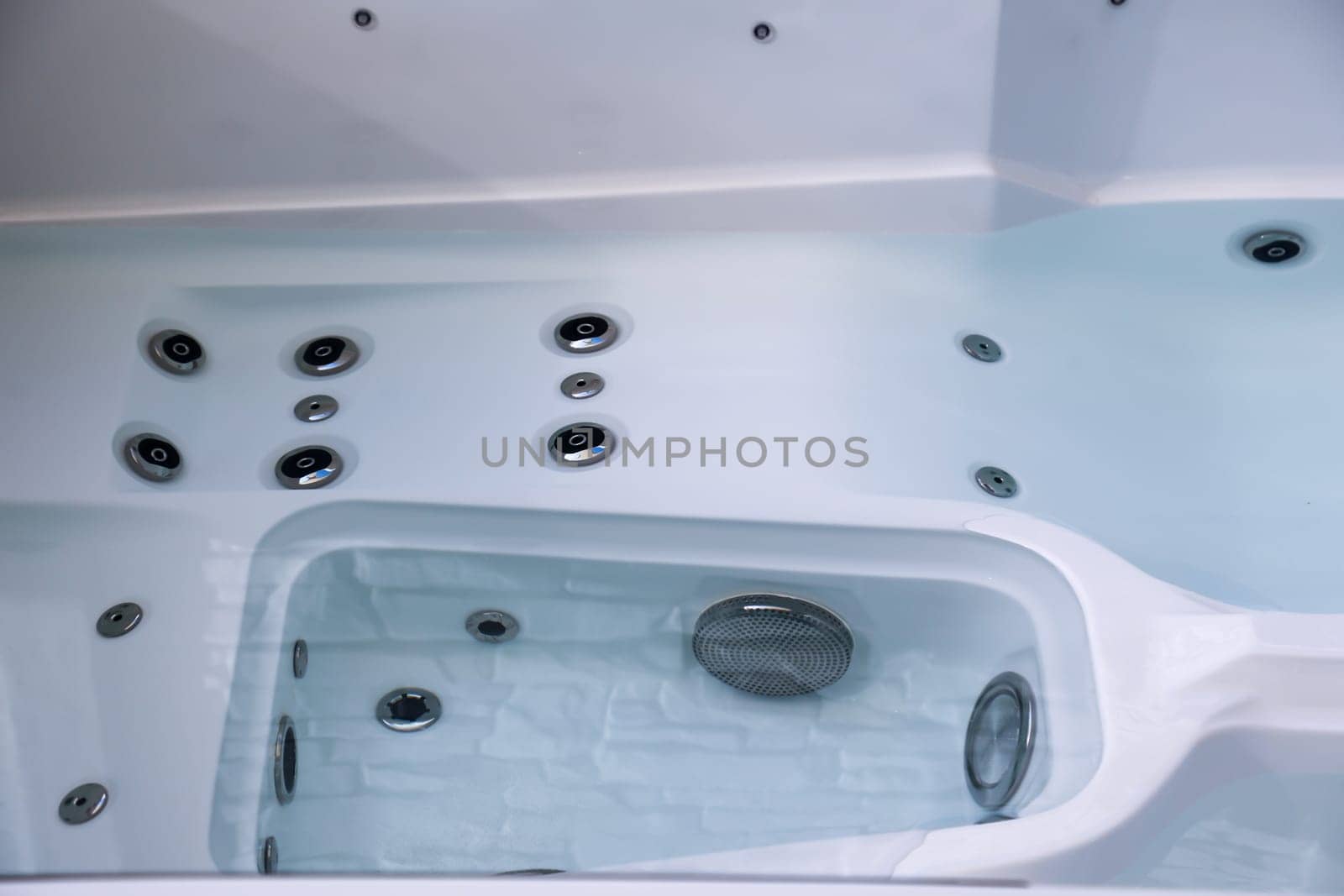 Details of a whirlpool with many jets for massage.