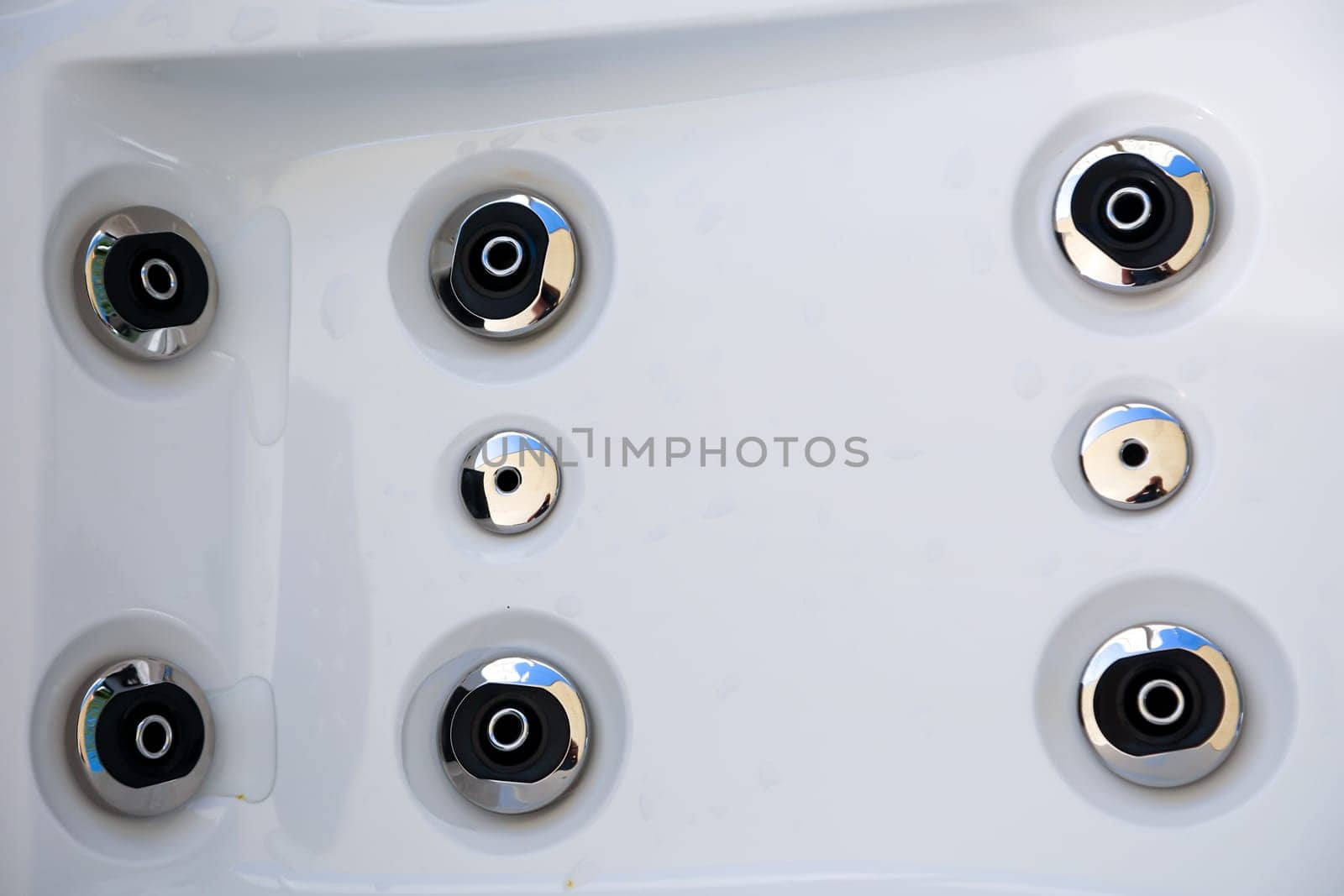 Details of a whirlpool with many jets for massage.