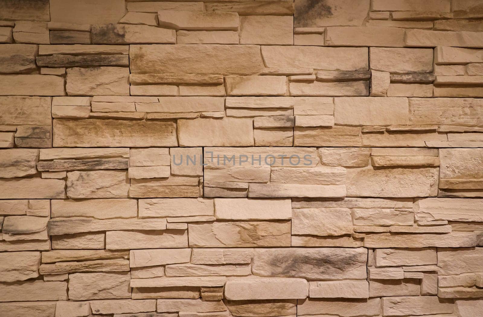 A stone wall with many broken stones. A stone texture.
