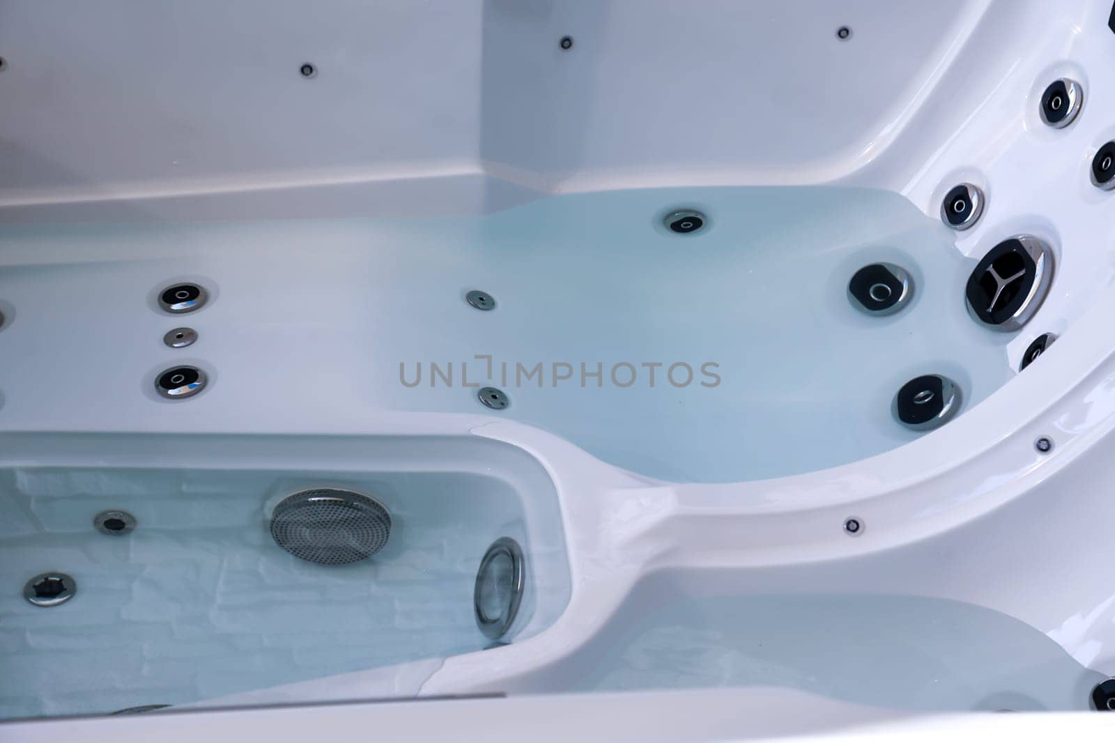 Details of a whirlpool with many jets for massage.