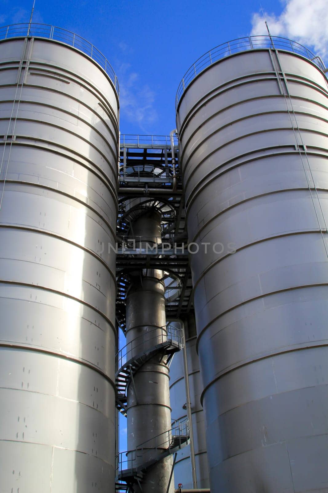 Two huge bunkers, storage or silos for industrial raw materials.