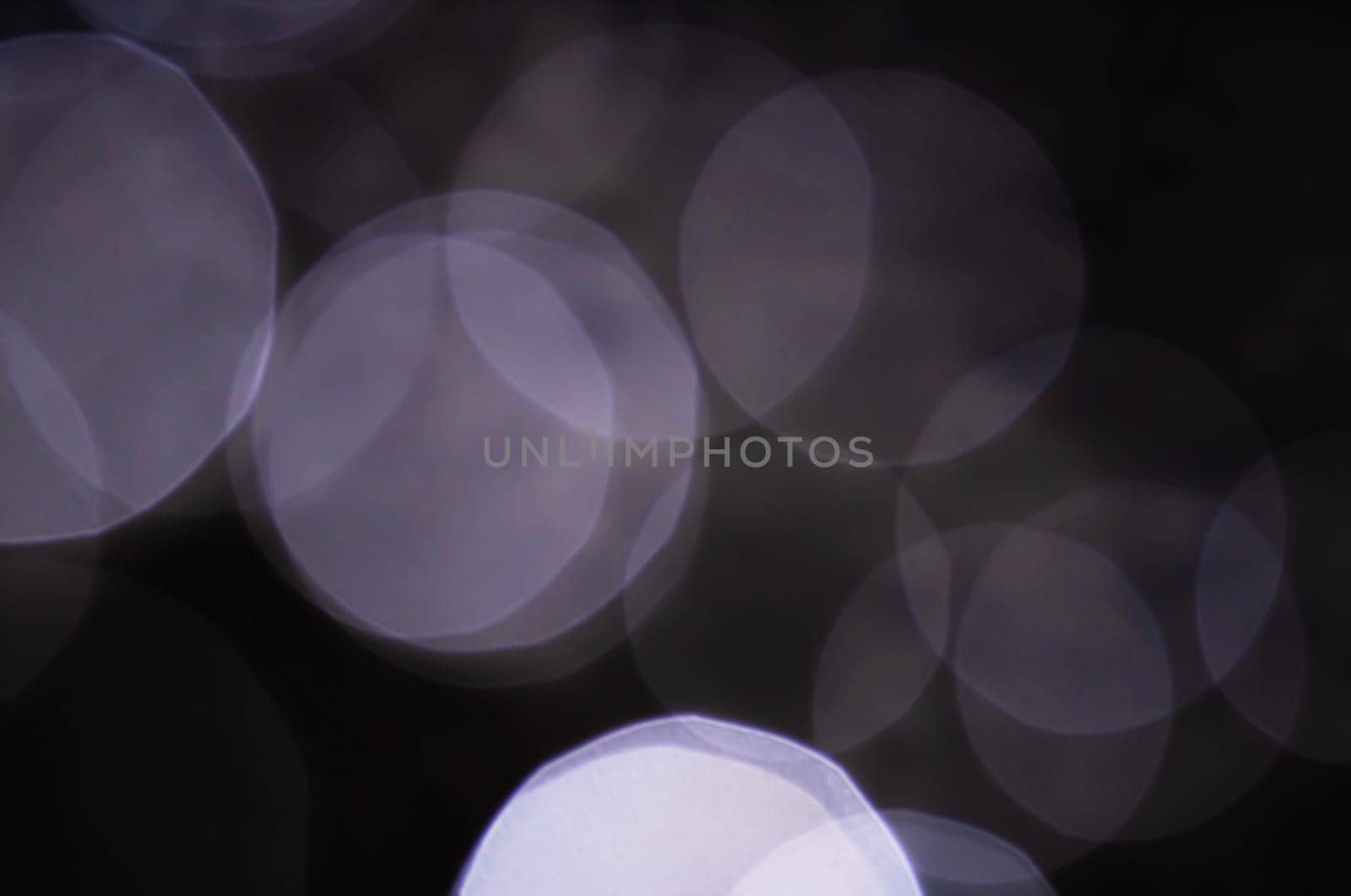 Light abstract dark bokeh christmas circle color glitter blurred black background