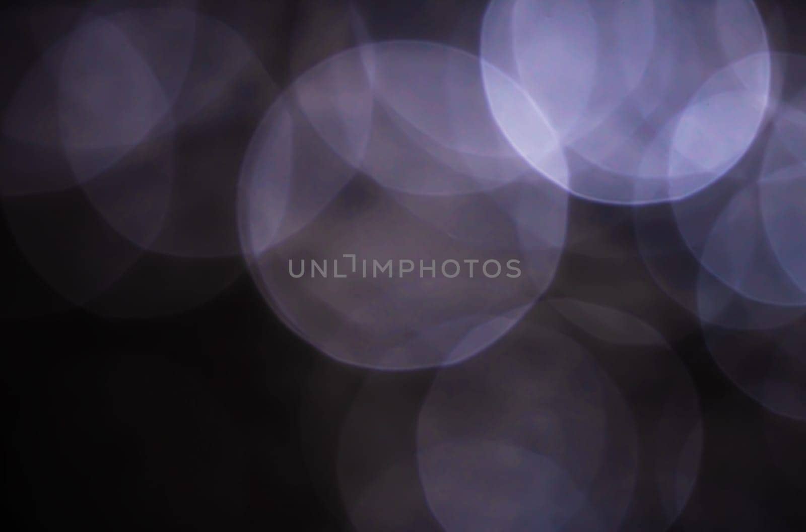 Light abstract dark bokeh christmas circle color glitter blurred black background