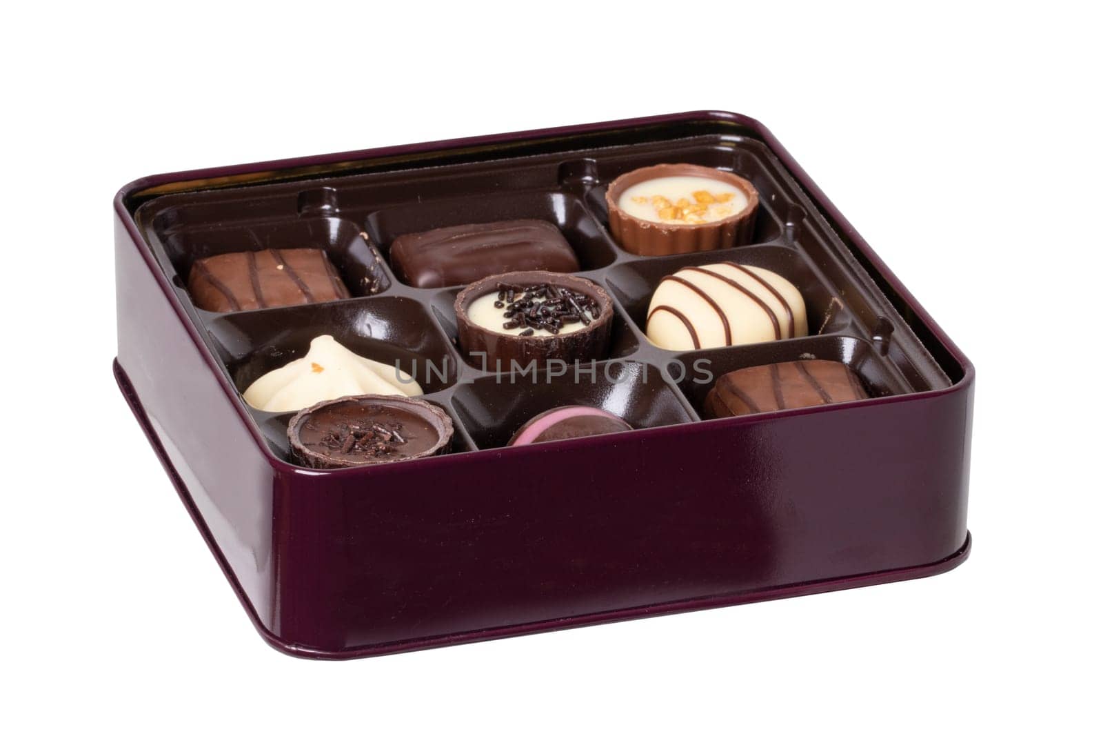 Closeup of box of fine chocolate candies in a beautiful box isolated on a white background. Clipping path. Surprise gift for Valentine's Day or other festive occasions. Macro.