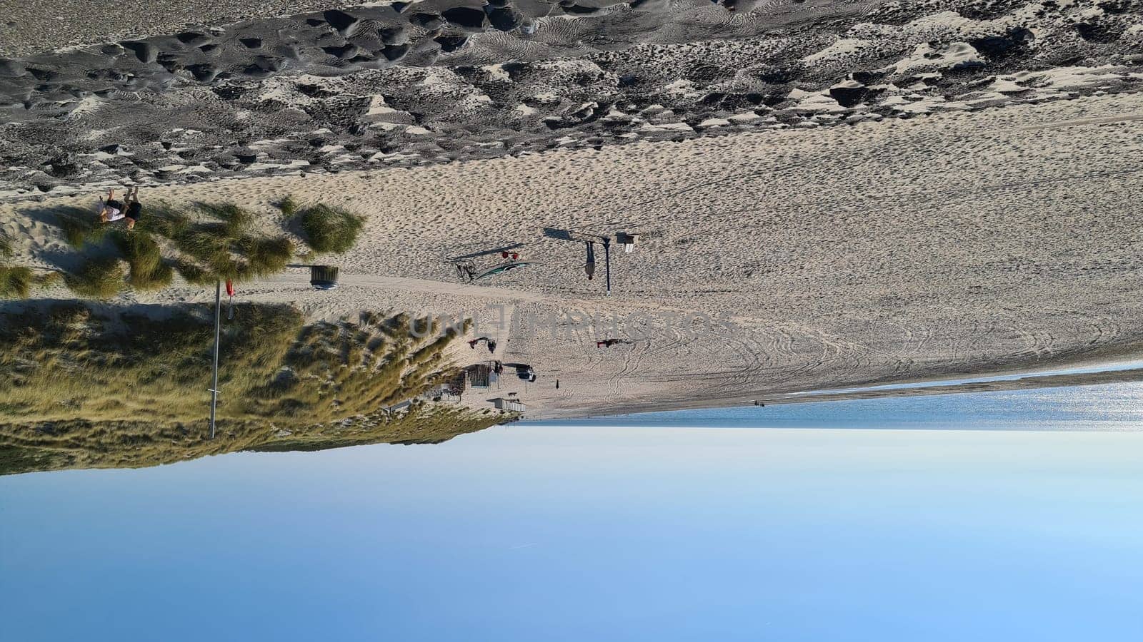View over the sea from the dune over North Sea and canal in Ouddorp, Zeeland province, The Netherlands. Outdoor scene of coast in Europe nature.
