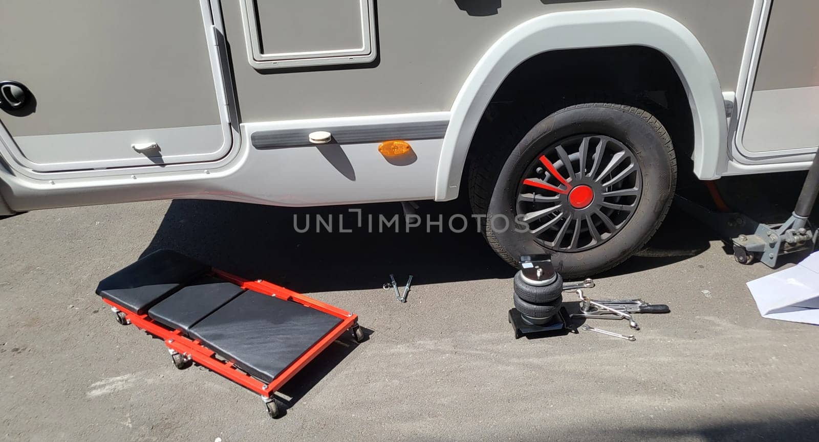 VELBERT, NRW, GERMANY - June 16, 2022:..Installation of an additional air suspension in a mobile home to increase the load capacity