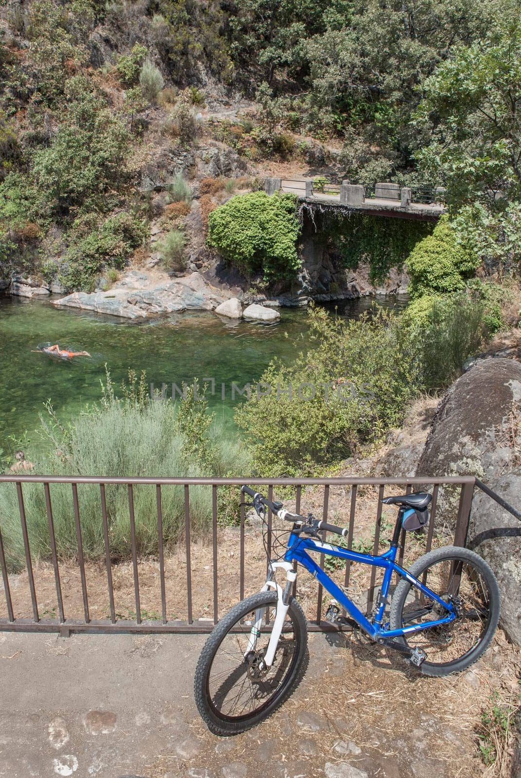 MTB bike parked beside La Maquina Natural swimming pool, Guijo de Santa Barbara, Spain. Great spot for triathlon practitioners