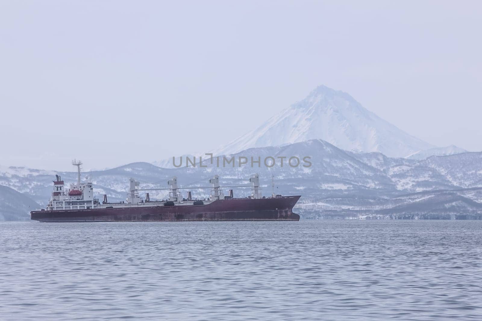 The Kamchatka Peninsula, Russia.Seaport in Petropavlovsk-Kamchatsky.Ships in the roadstead against the background of the volcano