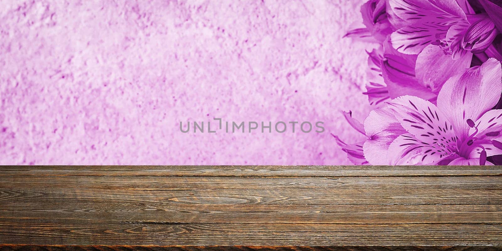 Background flowers on a textured stucco wall and blank wooden planks in the foreground. For product demonstrations, free space, layout, mockup, perspective board, background board.