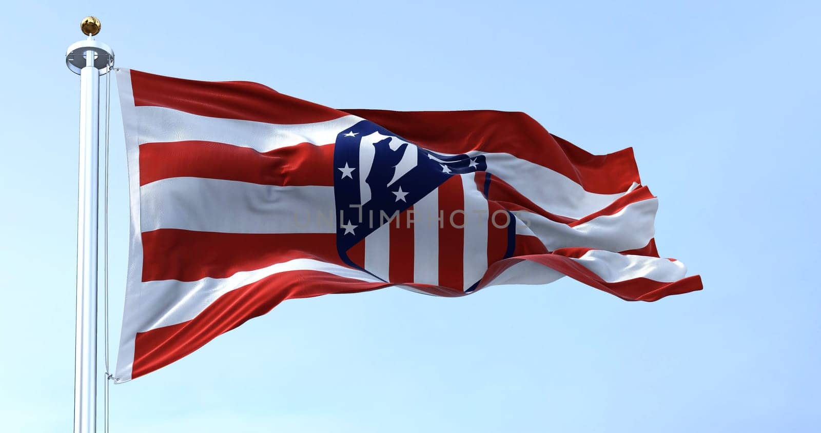 Madrid, Spain, May 2022: The flag of Atletico Madrid waving in the wind on a clear day. Atletico Madrid is a Spanish professional football club based in Madrid