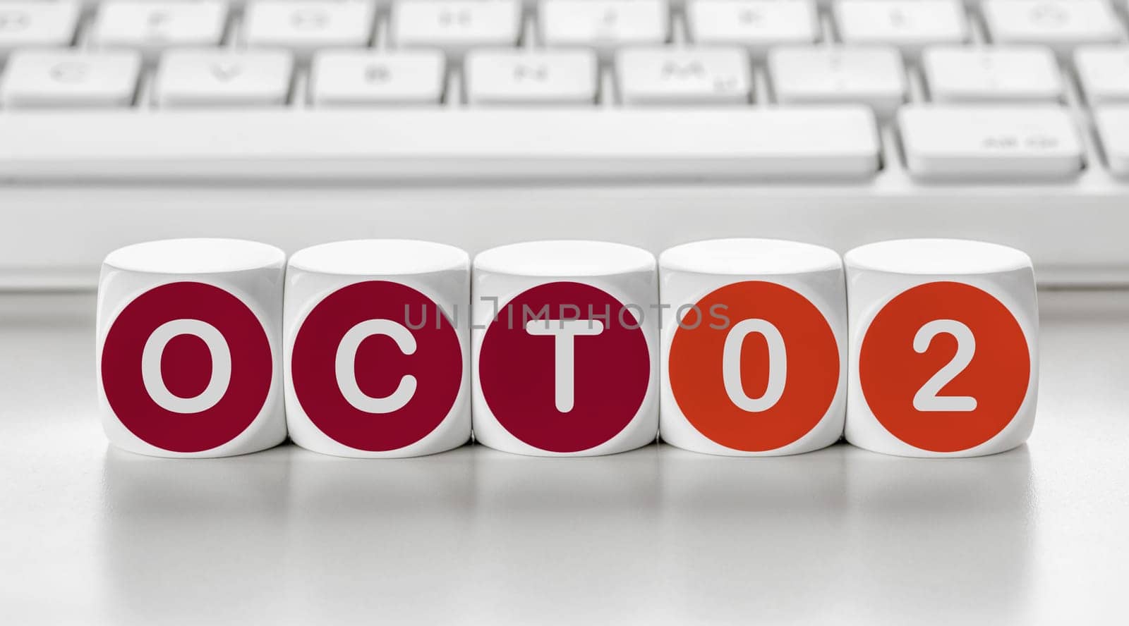 Letter dice in front of a keyboard - October 02