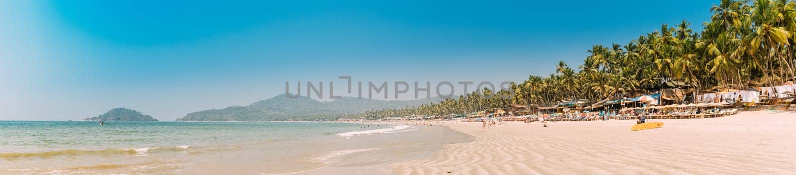 Canacona, Goa, India. Sunny Sky Over Calm Water Of Arabian Sea. Natural Landscape With Sandy Palolem Beach At Sunny Summer Day With Blue Sky.