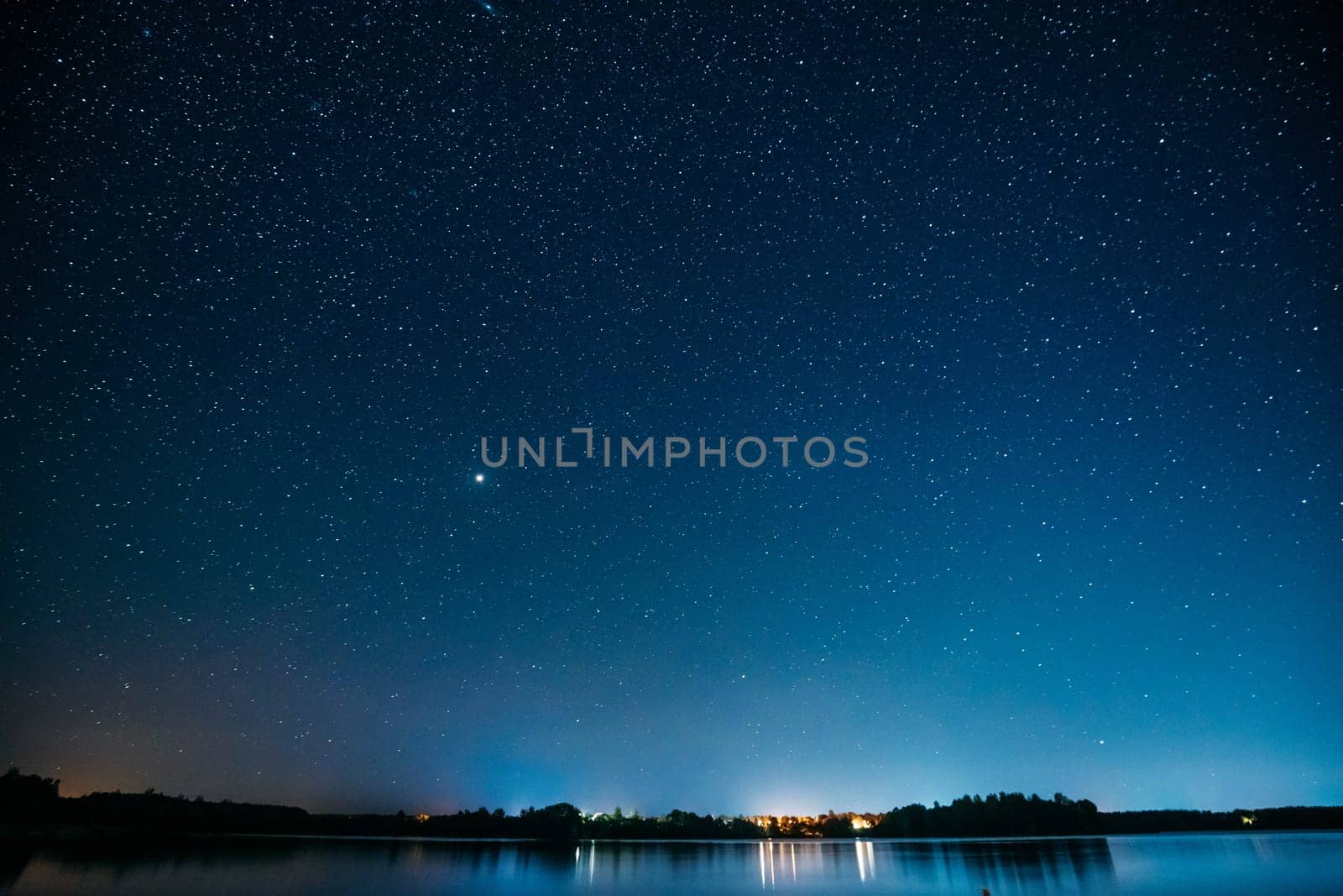 Village Novoye Lyadno, Lyepyel District, Vitebsk Province, Belarus. Night Stars Above Lepel Lake. Natural Starry Sky Background Backdrop Landscape.