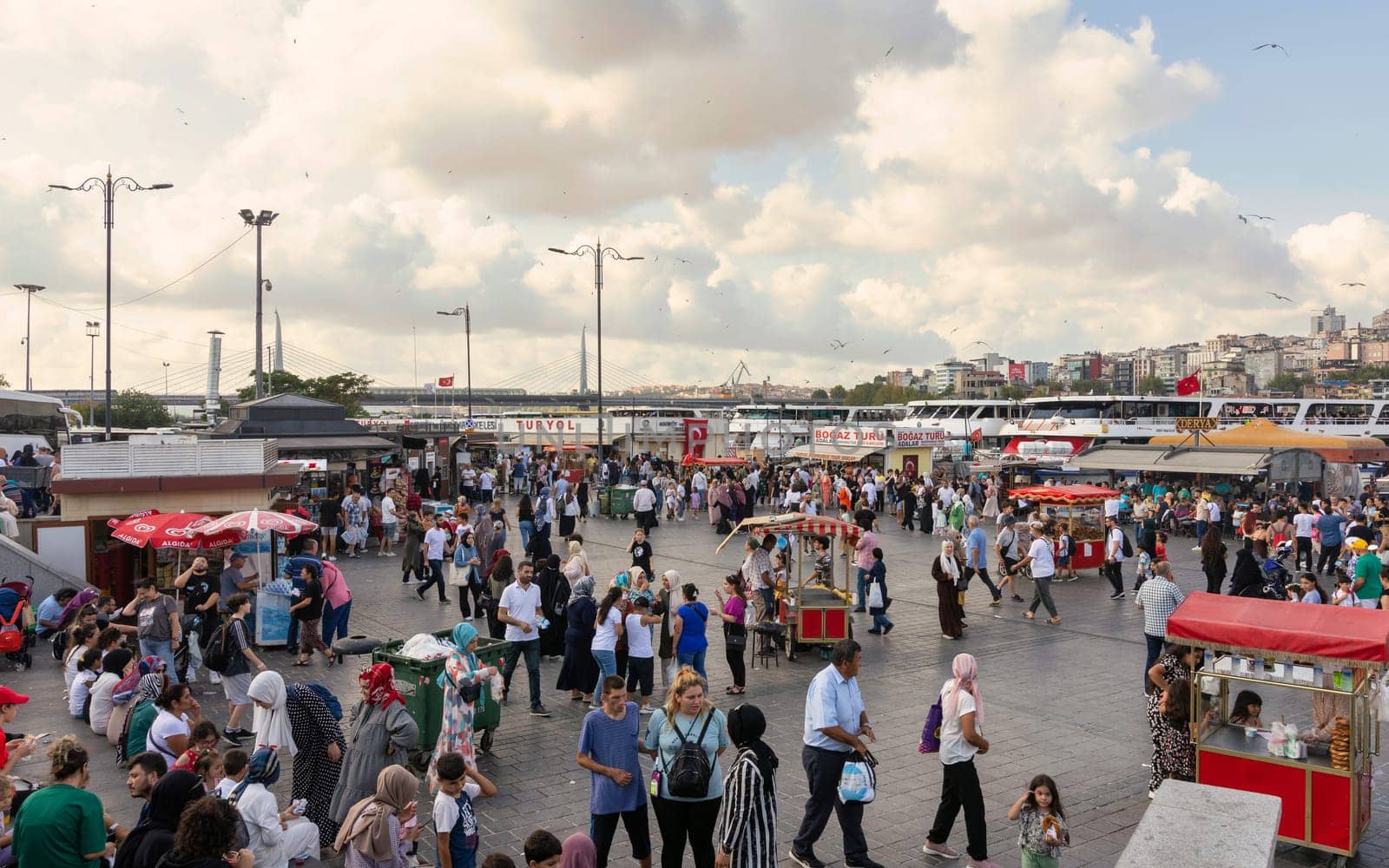 Istanbul, Turkey - August 30, 2022: Crowds of local citizens at Eminonu Plaza during the Victory Day holiday with background of Istanbul city view